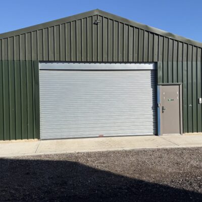 1,800 sq ft green clad steel barn unit with electric roller shutter door to let at Eight Ash Green, Colchester